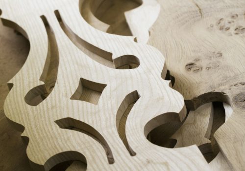 Close up of carved wooden furniture pieces.
